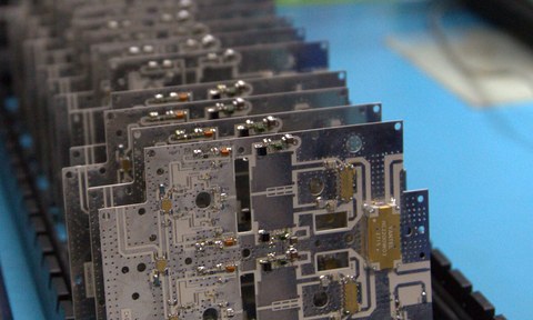 WV-branded printed circuit boards lined up on a production tray